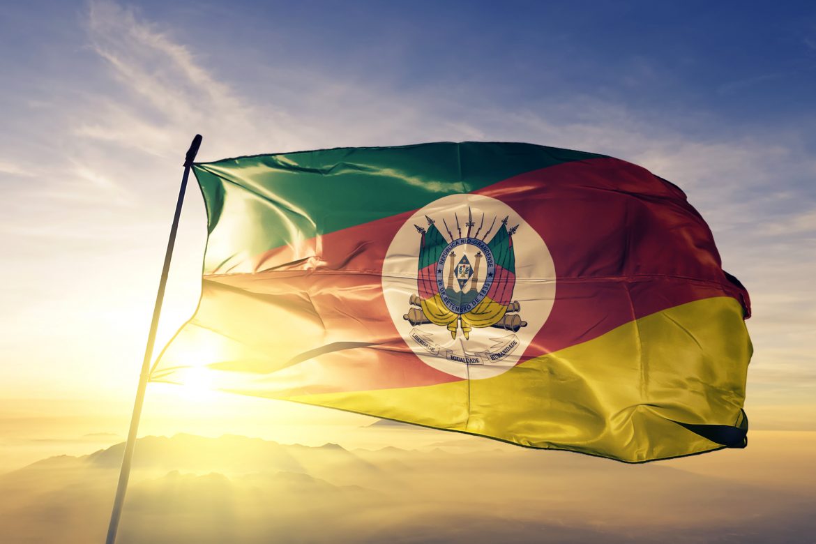 Rio Grande do Sul state of Brazil flag textile cloth fabric waving on the top sunrise mist fog